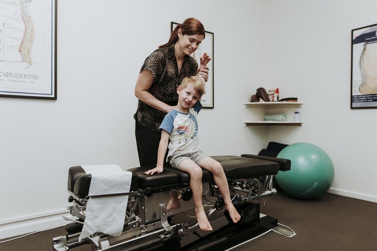 Cape Chiropractic team adjusting a young boy.