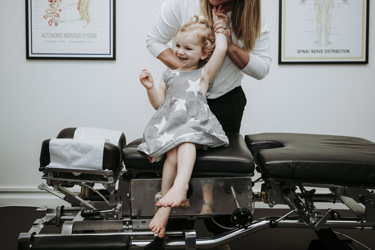 Chiropractor at Cape Chiropractic adjusting a young girl.